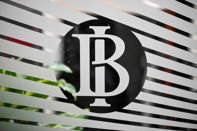 The logo of Bank Indonesia (Indonesia's Central Bank) is displayed on a glass door at its main building in Jakarta, on November 28, 2025. (Photo by BAY ISMOYO / AFP)