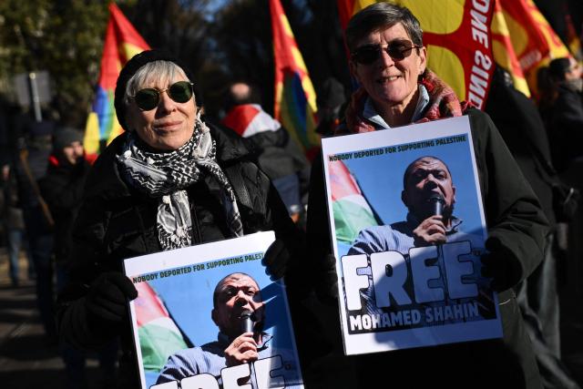 Protesters hold posters “Free Mohamed Shahin” one of the Iman of Turin detained in Italy, during a nationwide strike organized by the Unione Sindacale di Base (USB Union) in Turin, northwestern Italy on November 28, 2025. Trade unions have called a strike for public and private sector workers, affecting transport, schools, healthcare, and other public services. The reasons behind the strike are linked to the 2026 Economic Plan, which is being contested by the union groups CUB, USB, SGB, COBAS, and USI-CIT, who oppose the increase in military spending at the expense of essential public services. (Photo by MARCO BERTORELLO / AFP)