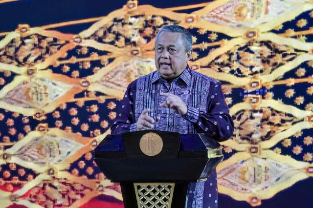 Governor of Bank Indonesia (Indonesia's Central Bank) Perry Warjiyo presents his paper on monetary policy during an annual meeting in Jakarta on November 28, 2025. (Photo by BAY ISMOYO / AFP)