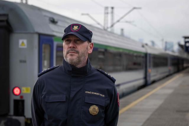 Pawel Kuskowski, the spokesman of the Railway Security Guard looks on during an AFP interview at the Eastern railway station in Warsaw, Poland, on November 27, 2025. The patrol is a part of "Operation Horizon," an effort launched by Poland earlier this month designed to boost rail security and protect critical infrastructure, following a series of diversions, which officials blame on Russia. (Photo by Wojtek RADWANSKI / AFP)