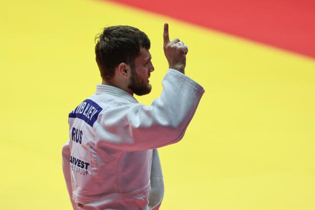 Russia's Ayub Bliev celebrates after competing against Mongolia's Ariunbold Enkhtaivan in the men's under 60 kg category during the Abu Dhabi Grand Slam tournament, in Abu Dhabi, on November 28, 2025. The Russian judo federation hailed "a historic decision" after the sport's global governing body announced on November 27, that their judokas are once again free to compete "under their national flag". But Ukraine's national judo federation blasted a decision which was contrary to "peace, justice, and responsibility" and vowed to "take all possible measures to prevent" its implementation. (Photo by Fadel SENNA / AFP)