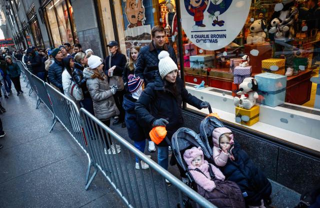 Costumers line up during Black Friday deals outside a toy store in New York City, November 28, 2025 (Photo by kena betancur / AFP)