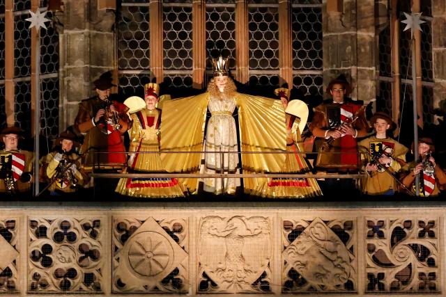 Nora Falk (C), this year's Christkind, stands on a balcony of the Church of Our Lady to officially open the Christmas market in Nuremberg, Germany on November 28, 2025. The Christmas market will be open until Christmas Eve, December 24. Nora Falk, 15 years old, was elected as the new Christkind in July 2025 for a two-year term. (Photo by Alexandra BEIER / AFP)
