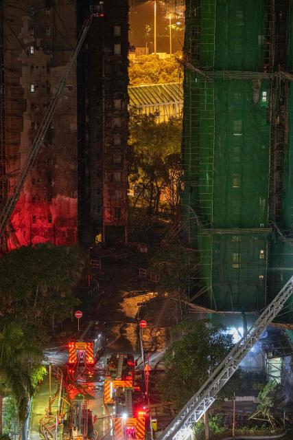A general view shows the aftermath of a major fire that swept through several apartment blocks at the Wang Fuk Court residential estate in Hong Kong's Tai Po district on November 28, 2025. The raging fire at Wang Fuk Court claimed at least 128 lives in what was the world's deadliest residential building fire since 1980, and authorities said Friday the status of around 200 people remained "unclear". (Photo by Philip FONG / AFP)