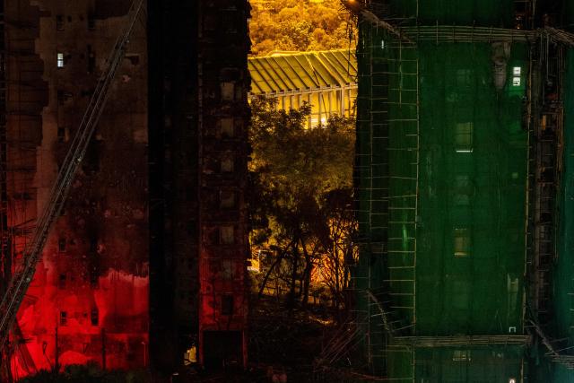 A general view shows the aftermath of a major fire that swept through several apartment blocks at the Wang Fuk Court residential estate in Hong Kong's Tai Po district on November 28, 2025. The raging fire at Wang Fuk Court claimed at least 128 lives in what was the world's deadliest residential building fire since 1980, and authorities said Friday the status of around 200 people remained "unclear". (Photo by Philip FONG / AFP)