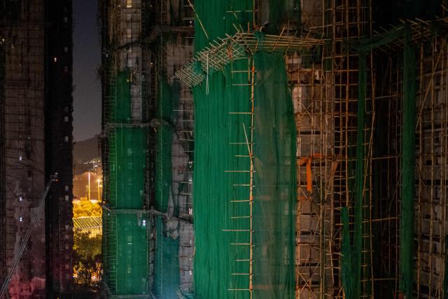 A general view shows the aftermath of a major fire that swept through several apartment blocks at the Wang Fuk Court residential estate in Hong Kong's Tai Po district on November 28, 2025. The raging fire at Wang Fuk Court claimed at least 128 lives in what was the world's deadliest residential building fire since 1980, and authorities said Friday the status of around 200 people remained "unclear". (Photo by Philip FONG / AFP)