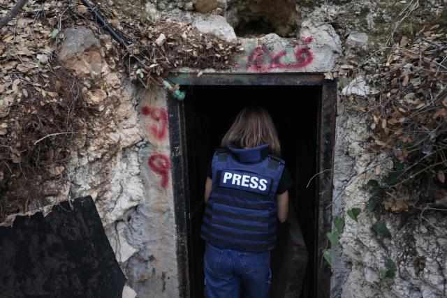 This photograph taken during a press tour organised by the Lebanese army shows a journalist entering an abandoned tunnel said to have been used by Hezbollah, in a mountainous valley on the outskirts of the southern village of Zibqin, on November 28, 2025. It was the first guided tour the army gave journalists since a November 2024 ceasefire sought to end over a year of hostilities between Hezbollah and Israel. (Photo by Anwar AMRO / AFP)