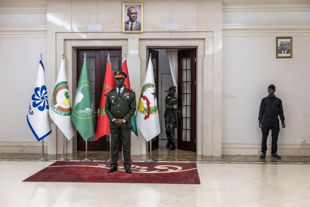 Transitional government President General Horta N'Tam (L) stands next to a portrait of freedom fighter and founder of the African Party for the Independence of Guinea and Cape Verde (PAIGC ) Amilcar Cabral during the swearing in ceremony at the Presidential Palace in Bissau, on November 28, 2025. The new military leader of Guinea-Bissau appointed an ally of the ousted president as prime minister on Friday, as international criticism grew of this week's coup.
The military took "total control" of the west African country on Wednesday -- a day before the provisional results of national elections were due to be announced -- and President Umaro Sissoco Embalo took refuge in neighbouring Senegal.
The true motives for the putsch, the fifth the west African country has suffered in 45 years, remain unclear. (Photo by PATRICK MEINHARDT / AFP)