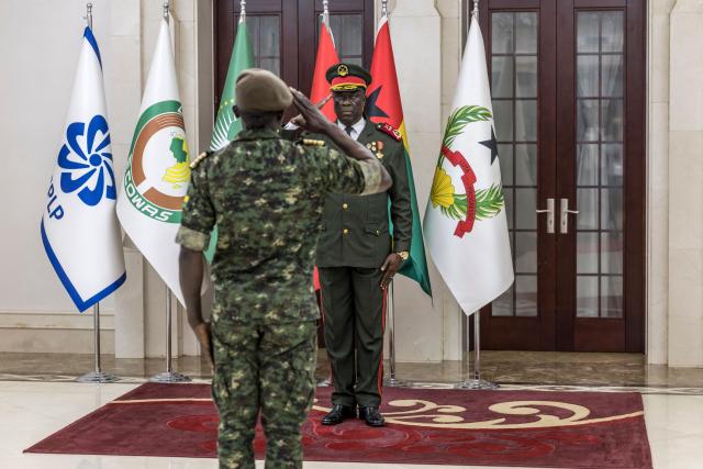 Transitional government President General Horta N'Tam (R) salutes an army officer during the swearing in ceremony at the Presidential Palace in Bissau, on November 28, 2025. The new military leader of Guinea-Bissau appointed an ally of the ousted president as prime minister on Friday, as international criticism grew of this week's coup.
The military took "total control" of the west African country on Wednesday -- a day before the provisional results of national elections were due to be announced -- and President Umaro Sissoco Embalo took refuge in neighbouring Senegal.
The true motives for the putsch, the fifth the west African country has suffered in 45 years, remain unclear. (Photo by PATRICK MEINHARDT / AFP)