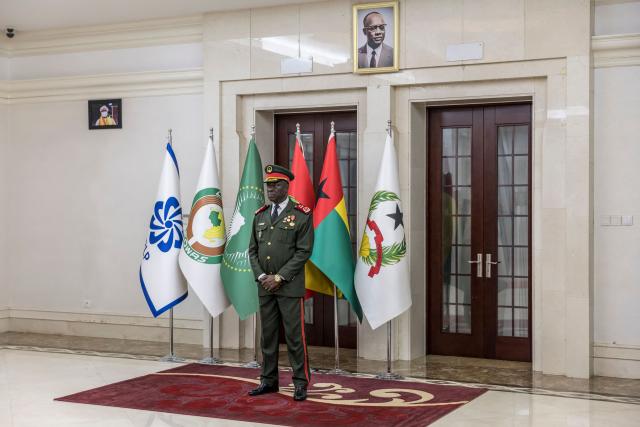 Transitional government President General Horta N'Tam stands next to a portrait of freedom fighter and founder of the African Party for the Independence of Guinea and Cape Verde (PAIGC) Amilcar Cabral during the swearing in ceremony at the Presidential Palace in Bissau, on November 28, 2025. The new military leader of Guinea-Bissau appointed an ally of the ousted president as prime minister on Friday, as international criticism grew of this week's coup.
The military took "total control" of the west African country on Wednesday -- a day before the provisional results of national elections were due to be announced -- and President Umaro Sissoco Embalo took refuge in neighbouring Senegal.
The true motives for the putsch, the fifth the west African country has suffered in 45 years, remain unclear. (Photo by PATRICK MEINHARDT / AFP)
