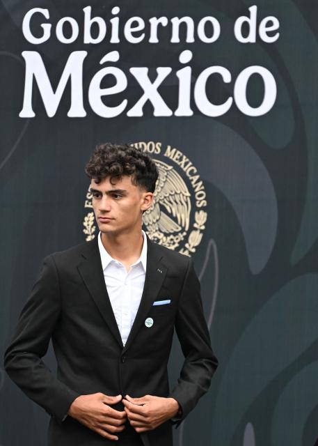 Mexican cyclist Isaac del Toro waits to receive the National Sports Award during a ceremony at the National Palace in Mexico City on November 28, 2025. (Photo by Yuri CORTEZ / AFP)
