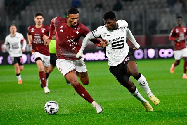 Metz's Ivorian midfielder #05 Jean-Philippe Gbamin (L) fights for the ball with Rennes' Swiss forward #07 Breel Embolo during the French L1 football match between Metz and Rennes at the Stade Saint-Symphorien in Metz, eastern France, on November 28, 2025. (Photo by Jean-Christophe VERHAEGEN / AFP)