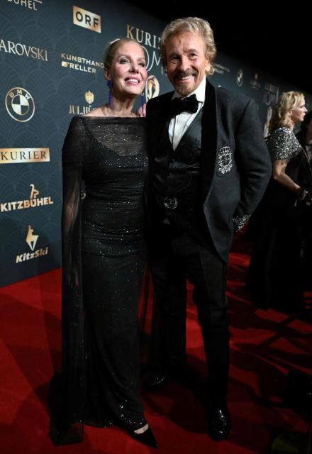 German host and entertainer Thomas Gottschalk and wife Karina Mross arrive on the red carpet to attend the award ceremony of the Kurier Romy Gala in Kitzbühel, Austria on November 28, 2025. (Photo by BARBARA GINDL / APA / AFP) / Austria OUT