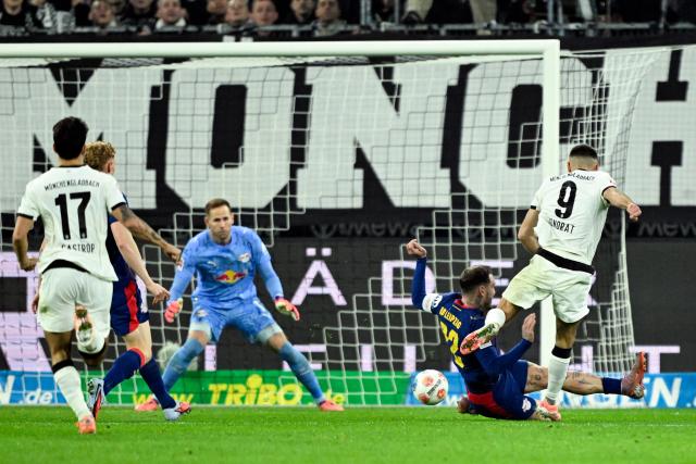 Moenchengladbach's French midfielder #09 Franck Honorat (R) shoots and scores a goal which was disallowed for offside during the German first division Bundesliga football match between Borussia Moenchengladbach and RB Leipzig in Moenchengladbach, western Germany on November 28, 2025. (Photo by INA FASSBENDER / AFP) / DFL REGULATIONS PROHIBIT ANY USE OF PHOTOGRAPHS AS IMAGE SEQUENCES AND/OR QUASI-VIDEO