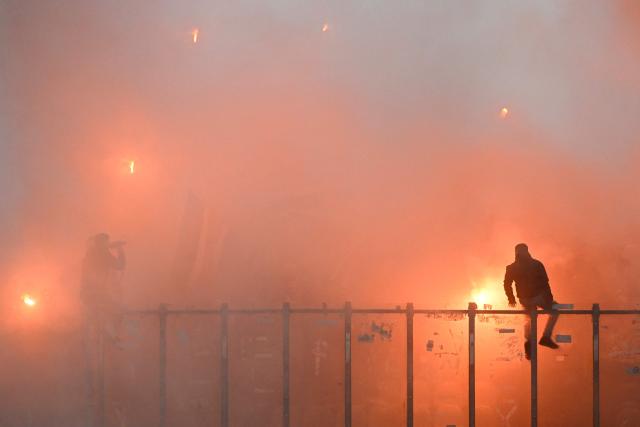 Rennes’ supporters light smoke flares during the French L1 football match between Metz and Rennes at the Stade Saint-Symphorien in Metz, eastern France, on November 28, 2025. (Photo by Jean-Christophe VERHAEGEN / AFP)