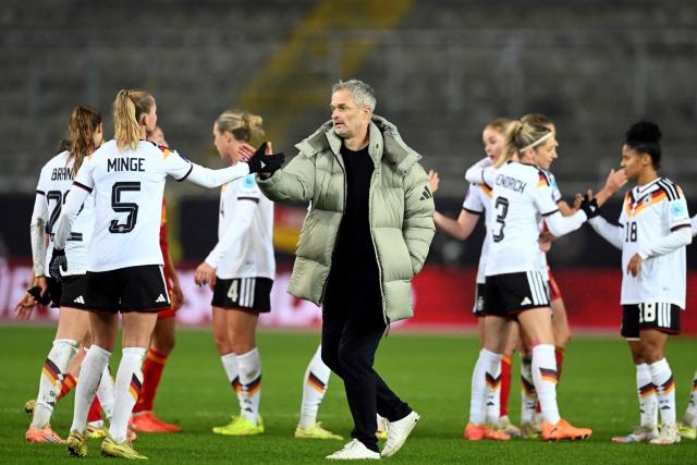 Germany's head coach Christian Wueck reacts with players after the UEFA Women's Nations League first leg final football match between Germany and Spain in Kaiserslautern, western Germany on November 28, 2025. The match ended in a 0-0 draw. (Photo by THOMAS KIENZLE / AFP)