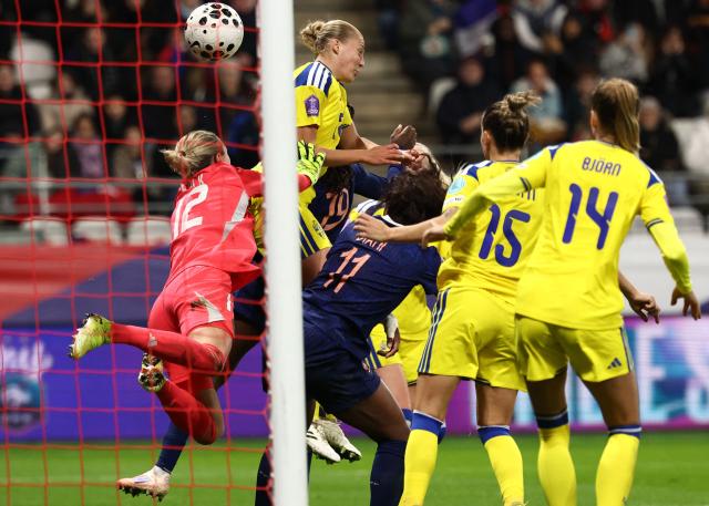 Sweden's goalkeeper #12 Jennifer Falk (L) concedes a goal during the Women's Nations League third place playoff first leg football match between France and Sweden at Auguste-Delaune stadium in Reims, on November 28, 2025. (Photo by FRANCK FIFE / AFP)