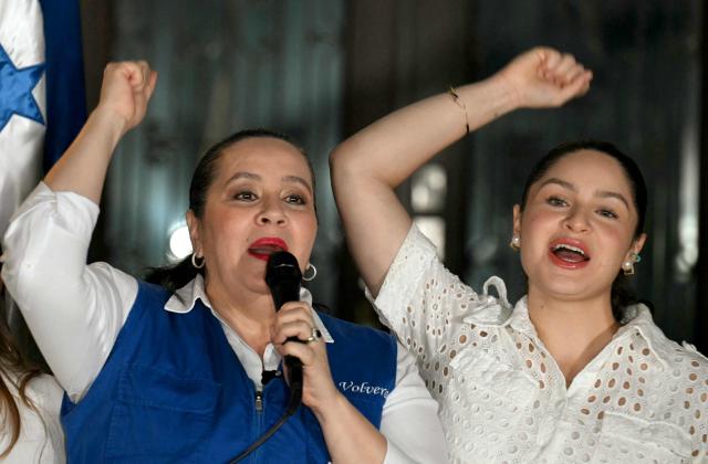 Ana Garcia de Hernandez (C), wife of former Honduras President Juan Orlando Hernandez, talks to the media during a press conference in Tegucigalpa on November 28, 2025. US President Donald Trump said Friday he will pardon Honduran ex-president Juan Orlando Hernandez, who was convicted of drug trafficking and sentenced to 45 years in prison in the US. (Photo by Marvin RECINOS / AFP)