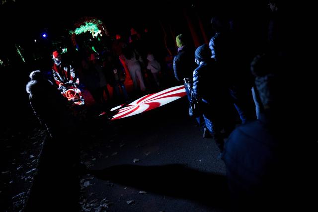 People visit the Smithsonian National Zoo during their holiday zoo lights exhibit November 28, 2025, in Washington, DC. (Photo by Brendan Smialowski / AFP)