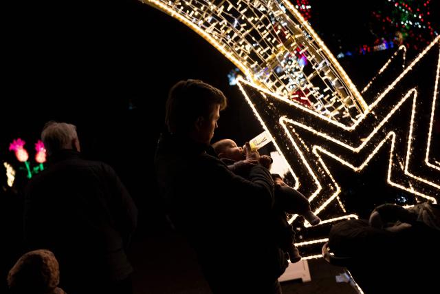 People visit the Smithsonian National Zoo during their holiday zoo lights exhibit November 28, 2025, in Washington, DC. (Photo by Brendan Smialowski / AFP)