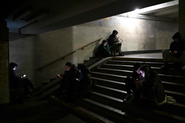 People take shelter at a metro station during an air attack in Kyiv on November 29, 2025, amid the Russian invasion of Ukraine. Loud explosions were heard in the Ukrainian capital Kyiv early on November 29, 2025, the mayor and AFP journalists said. (Photo by Sergei GAPON / AFP)