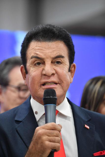 Salvador Nasralla, Honduran presidential candidate for the opposition Libertad party, speaks about the pardon granted to former president Juan Orlando Hernandez during a press conference in Tegucigalpa on November 28, 2025. US President Donald Trump said Friday he will pardon Honduran ex-president Juan Orlando Hernandez, who was convicted of drug trafficking and sentenced to 45 years in prison in the US. (Photo by Orlando SIERRA / AFP)