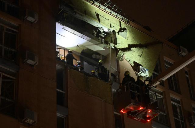 Rescuers work in a damaged residential building following a drone attack to Kyiv on November 29, 2025, amid Russian invasion in Ukraine. A Russian drone attack targeted the Ukrainian capital in the early hours of November 29, 2025, wounding seven people, authorities in Kyiv said. (Photo by Genya SAVILOV / AFP)