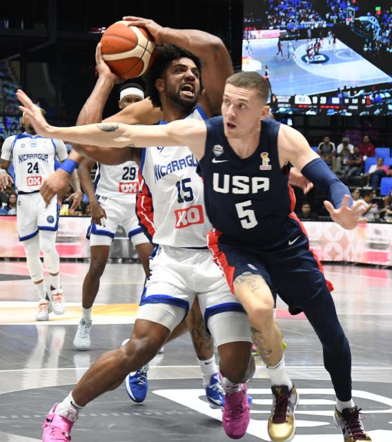 Nicaragua's Norchad Omier (L) dribbles against USA's Kyle Guy during the FIBA Basketball World Cup 2027 Americas qualifiers Group A match between Nicaragua and USA at the Polideportivo Alexis Arguello stadium in Managua on November 28, 2025. (Photo by AFP)