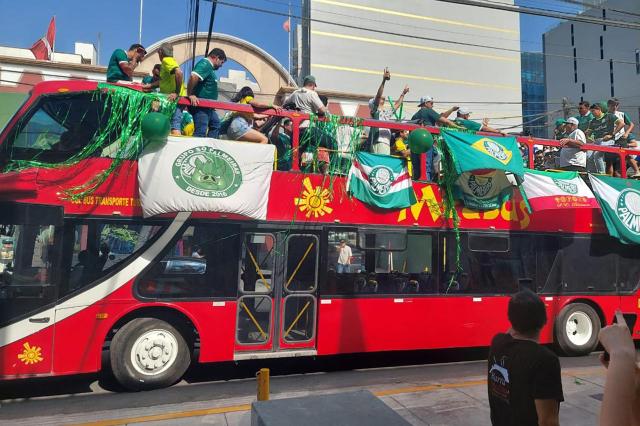 Palmeiras fans cheer for their team while riding a tour bus on the eve of the all-Brazilian Copa Libertadores final football match between Palmeiras and Flamengo in Lima on November 28, 2025. A Palmeiras fan who had traveled to Lima to watch the 2025 Copa Libertadores final against Flamengo died on Friday in a traffic accident, Peruvian police reported. The accident occurred in the afternoon on the ring road along Lima’s bay, aboard a tour bus packed with euphoric Palmeiras supporters. (Photo by Carlos MANDUJANO / AFP)