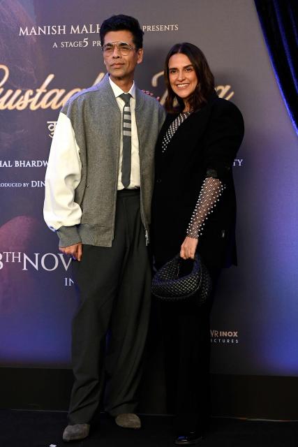 Bollywood film director Karan Johar and actress Neha Dhupia attend the special screening of upcoming film ‘Gustaakh Ishq’ in Mumbai on November 28, 2025. (Photo by SUJIT JAISWAL / AFP)