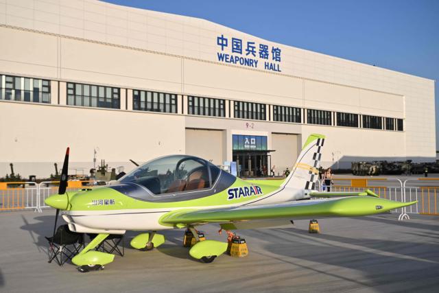 A civilian aircraft on static display is seen outside the weaponry hall of the Aero Asia 2025 in Zhuhai, in southern China's Guangdong province on November 28, 2025. Aero Asia 2025 is an international aviation and aerospace exhibition that runs between November 27 and 30. (Photo by Hector RETAMAL / AFP)