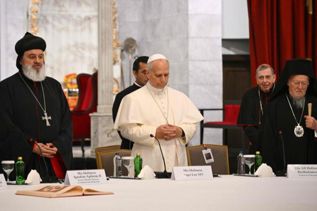 Pope Leo XIV stands between patriarch Mor Ignatius Aphrem II (L) and patriarch Bortholomew I as he arrives for a private meeting with religious leaders at the Mor Ephrem Syriac Orthodox Church, in Istanbul on November 29, 2025. (Photo by Andreas SOLARO / AFP)