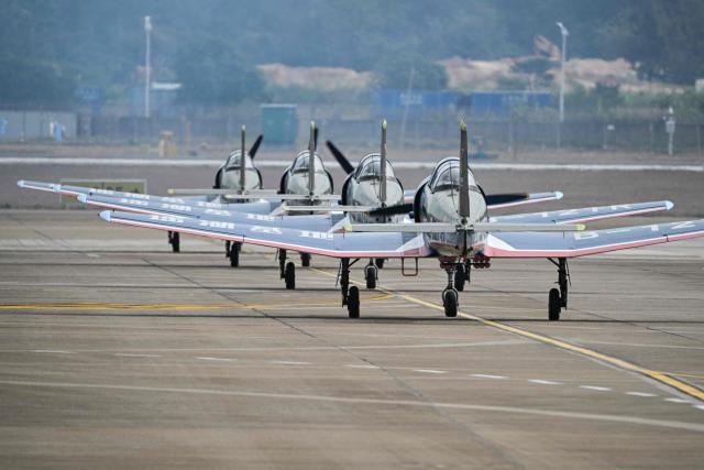 The Chinese Red Star Aerobatic team prepares to perform during the Aero Asia 2025 in Zhuhai, in southern China's Guangdong province on November 29, 2025. Aero Asia 2025 is an international aviation and aerospace exhibition that runs between November 27 and 30. (Photo by Hector RETAMAL / AFP)