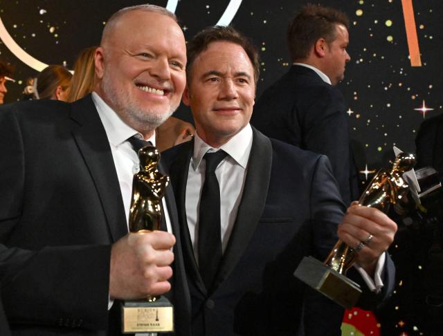German comedian and actor Michael Herbig (R) and German host and entertainer Stefan Raab pose with their trophies during the award ceremony of the Kurier Romy Gala in Kitzbühel, Austria on November 28, 2025. (Photo by BARBARA GINDL / APA / AFP) / Austria OUT
