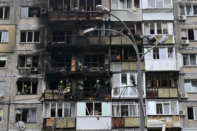 Ukrainian rescuers work in a damaged residential building following a drone attack in Kyiv on November 29, 2025, amid the Russian invasion in Ukraine. A Russian drone attack targeted the Ukrainian capital in the early hours of November 29, 2025, killing one person and wounding seven, authorities in Kyiv said. (Photo by Genya SAVILOV / AFP)