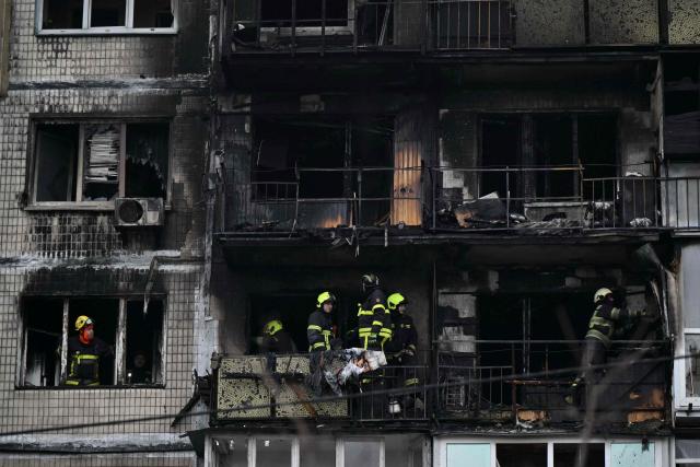 Ukrainian rescuers work in a damaged residential building following a drone attack in Kyiv on November 29, 2025, amid the Russian invasion in Ukraine. A Russian drone attack targeted the Ukrainian capital in the early hours of November 29, 2025, killing one person and wounding seven, authorities in Kyiv said. (Photo by Genya SAVILOV / AFP)