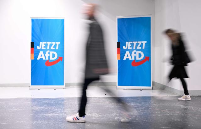 Participants enter the venue of a two-day convention of far-right Alternative for Germany (AfD) party to establish its new youth organisation at the exhibition halls in Giessen, western Germany, on November 29, 2025. During the convention, Germany's AfD plans to establish its new youth organisation, to draft the organisation's statutes and elect its new leadership. The AfD's former youth organisation, Junge Alternative (Young Alternative), dissolved in spring 2025 after the party separated from it. Massive counter-protests from politicians and civil society have already been announced. The city announced that it intended to cordon off the entire area around the AfD event venue due to police security concerns. The anti-AfD protests are to be moved to the other side of the Lahn River. (Photo by Kirill KUDRYAVTSEV / AFP)