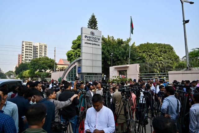 People and journalists gather in front of Evercare hospital in Dhaka on November 29, 2025, as Bangladesh's former prime minister Khaleda Zia is undergoing treatment in the intensive care unit. Former prime minister Khaleda Zia's health deteriorated since being admitted to hospital, prompting her family and party members to urge citizens to pray for her speedy recovery on November 29. (Photo by MUNIR UZ ZAMAN / AFP)