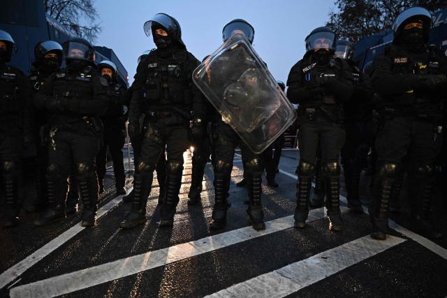 Police stand by during a protest against a two-day convention of far-right Alternative for Germany (AfD) party to establish its new youth organisation in Giessen, western Germany, early on November 29, 2025. During the convention, Germany's AfD plans to establish its new youth organisation, to draft the organisation's statutes and elect its new leadership. The AfD's former youth organisation, Junge Alternative (Young Alternative), dissolved in spring 2025 after the party separated from it. Massive counter-protests from politicians and civil society have already been announced. The city announced that it intended to cordon off the entire area around the AfD event venue due to police security concerns. The anti-AfD protests are to be moved to the other side of the Lahn River. (Photo by Kirill KUDRYAVTSEV / AFP)