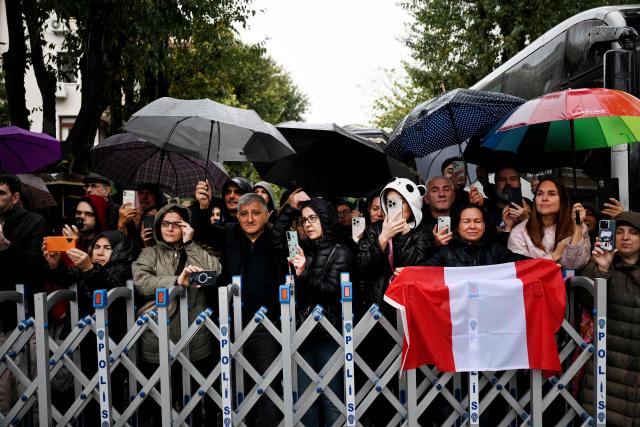 People react and take photos in front of the Mor Ephrem Syriac Orthodox Church, where Pope Leo XIV meets with religious leaders, in Istanbul on November 29, 2025. (Photo by YASIN AKGUL / AFP)