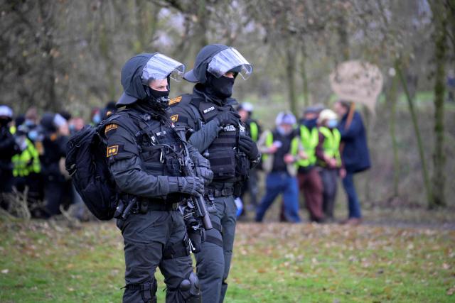 Police patrol near the venue of a two-day convention of far-right Alternative for Germany (AfD) party to establish its new youth organisation in Giessen, western Germany, on November 29, 2025. A meeting set to launch the new youth wing of the far-right Alternative for Germany (AfD) was delayed on November 29 as thousands of protestors blocked access to the event venue. Thousands of anti-AfD protestors began descending on the town of Giessen from early morning, with police also out in force. One of the protest organisations, "Resist", said that it blocked several routes towards the AfD meeting and had gathered 15,000 people. (Photo by Sascha Schuermann / AFP)