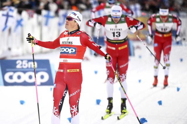 Norway's Johannes Hosflot Klaebo crosses the finish line to win ahead of Sweden's Edvin Anger and Norway's Erik Valnes during the men's cross country classic skiing sprint final at the FIS World Cup Ruka Nordic in Kuusamo, Finland, on November 29, 2025. (Photo by Vesa Moilanen / Lehtikuva / AFP) / Finland OUT