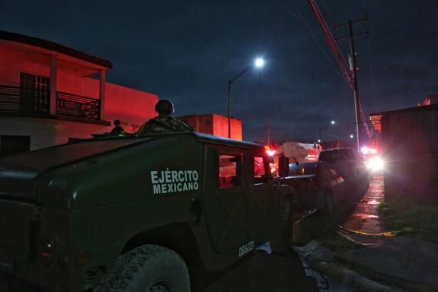 A vehicle of the Mexican army waits outside a house, where clandestine fireworks were manufactured, after it exploded leaving three people dead and six injured, in the municipality of Pesqueria, Nuevo Leon state, Mexico, on November 28, 2025. (Photo by Julio Cesar AGUILAR / AFP)