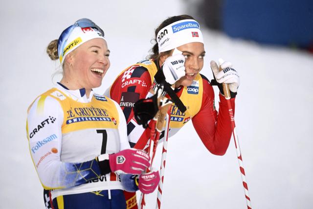 Winner Kristine Stavas Skistad of Norway (R) and second placed Jonna Sundling of Sweden react after women's cross country classic skiing sprint final at the FIS World Cup Ruka Nordic in Kuusamo, Finland, on November 29, 2025. (Photo by Vesa Moilanen / Lehtikuva / AFP) / Finland OUT