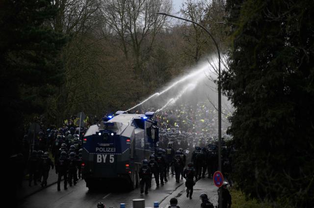 The police use water cannons to disperse protesters against a two-day convention of far-right Alternative for Germany (AfD) party to establish its new youth organisation in Giessen, western Germany, on November 29, 2025. During the convention, Germany's AfD plans to establish its new youth organisation, to draft the organisation's statutes and elect its new leadership. The AfD's former youth organisation, Junge Alternative (Young Alternative), dissolved in spring 2025 after the party separated from it. Massive counter-protests from politicians and civil society have already been announced. The city announced that it intended to cordon off the entire area around the AfD event venue due to police security concerns. The anti-AfD protests are to be moved to the other side of the Lahn River. (Photo by Sascha Schuermann / AFP)