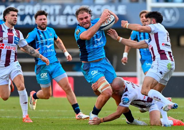 Montpellier’s French back row Lenni Nouchi (C) is tackled by Bordeaux-Begles' French scrum-half Maxime Lucu (R) during the French Top14 rugby union match between Montpellier Herault Rugby and Union Bordeaux-Begles (UBB) at the GGL Stadium in Montpellier, southern France on November 29, 2025. (Photo by Sylvain THOMAS / AFP)