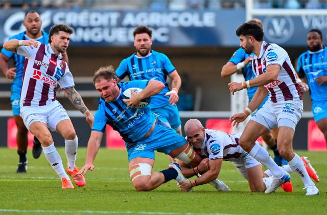 Montpellier’s French back row Lenni Nouchi (C) is tackled by Bordeaux-Begles' French scrum-half Maxime Lucu (R) during the French Top14 rugby union match between Montpellier Herault Rugby and Union Bordeaux-Begles (UBB) at the GGL Stadium in Montpellier, southern France on November 29, 2025. (Photo by Sylvain THOMAS / AFP)