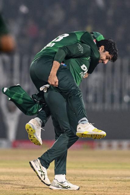 Pakistan's Abrar Ahmed (R) celebrates with teammate Saim Ayub after taking the wicket of Sri Lanka's Pavan Rathnayake during the Twenty20 international Tri-Series final cricket match between Pakistan and Sri Lanka at the Rawalpindi Cricket Stadium in Rawalpindi on November 29, 2025. (Photo by Aamir QURESHI / AFP)