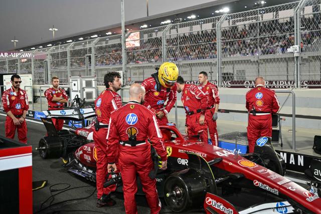 Ferrari's British driver Lewis Hamilton gets in his car before the start of the sprint race ahead of the Formula One Qatar Grand Prix at the Lusail International Circuit in Lusail on November 29, 2025. (Photo by Andrej ISAKOVIC / AFP)