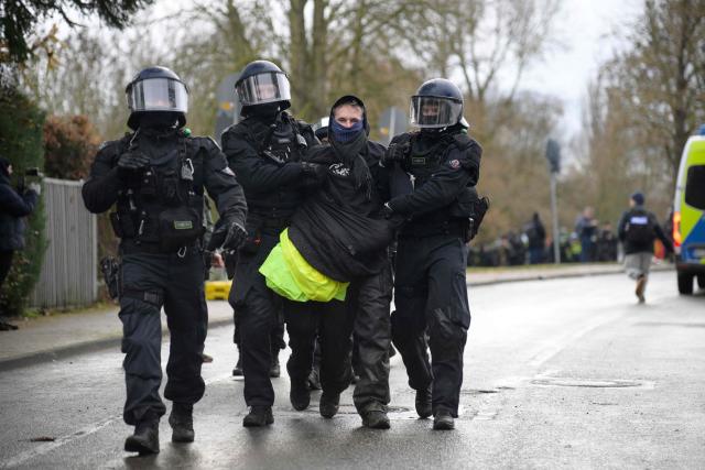 Police arrest a protestor near the venue of a two-day convention of far-right Alternative for Germany (AfD) party to establish its new youth organisation in Giessen, western Germany, on November 29, 2025. (Photo by Sascha Schuermann / AFP)